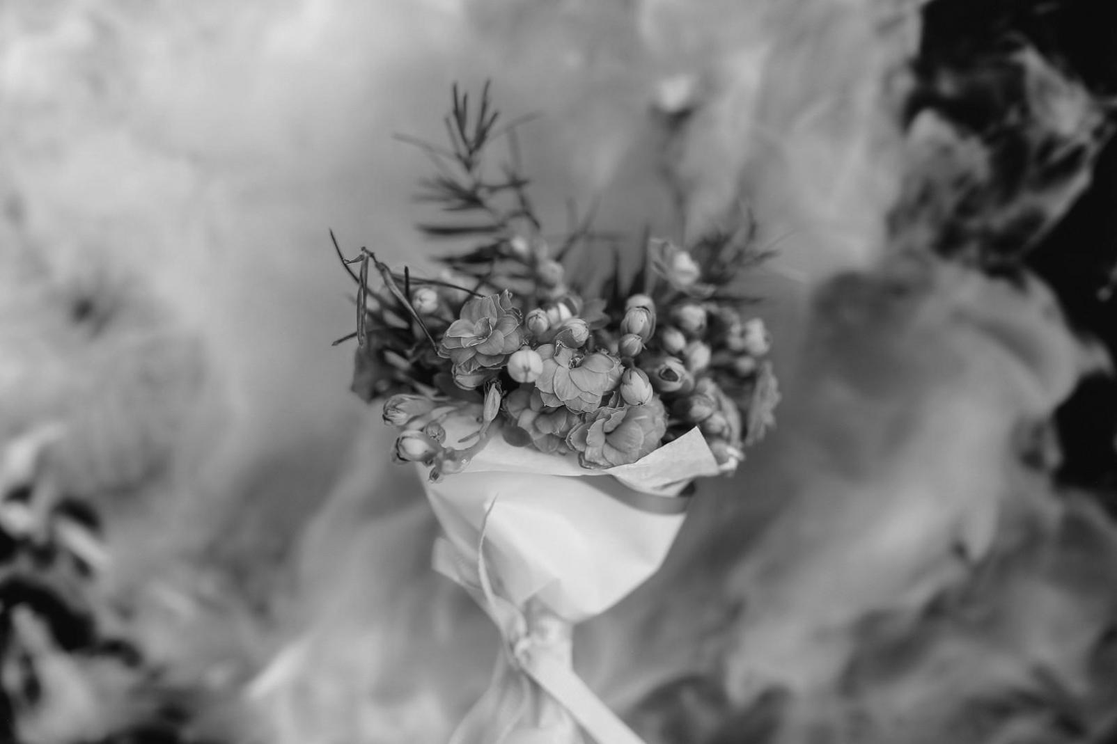 Professional flower arrangement workspace showing design tools and botanical materials